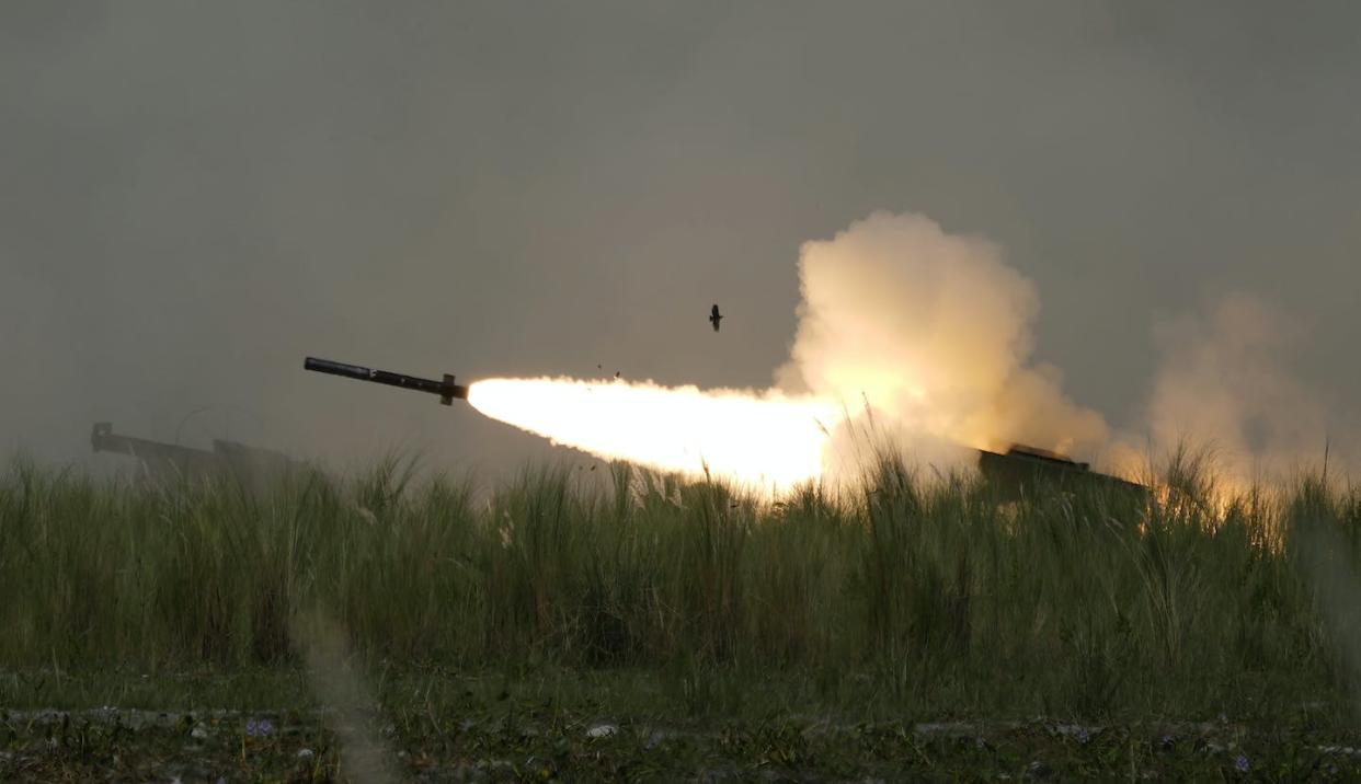 A U.S. artillery rocket system fires a missile during annual combat drills between the Philippine Marine Corps and U.S. Marine Corps in the northern Philippines in October 2022 in a region where the United States says it wants to deter China. (AP Photo/Aaron Favila)