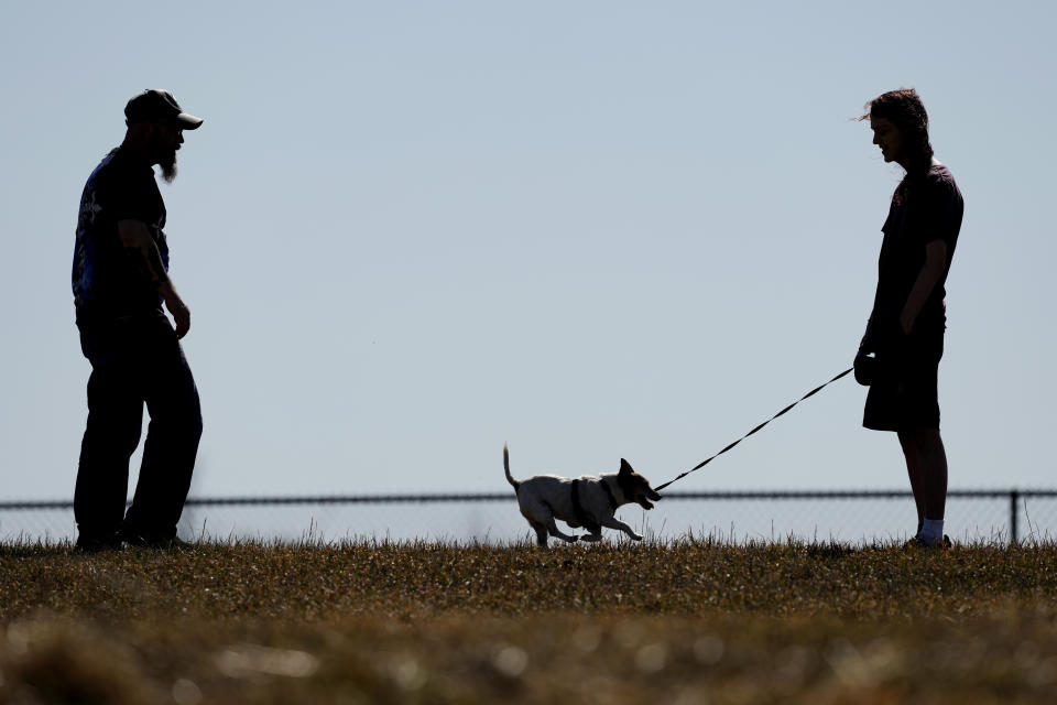 Dusty Farr talks with his transgender daughter at a park near Smithville, Mo., Sunday, Feb. 25, 2024. Farr is suing the Platt County School District after his daughter was suspended for using the girl's bathroom at the Missouri high school she attended. (AP Photo/Charlie Riedel)