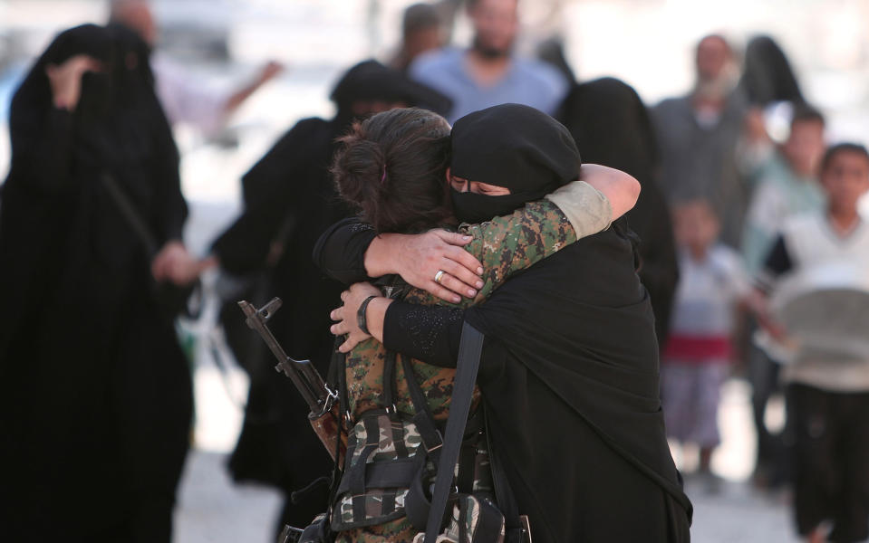 <p>A woman embraces a Syria Democratic Forces (SDF) fighter after she was evacuated with others by the SDF from an Islamic State-controlled neighbourhood of Manbij, in Aleppo Governorate, Syria, Aug. 12, 2016. (REUTERS/Rodi Said) </p>