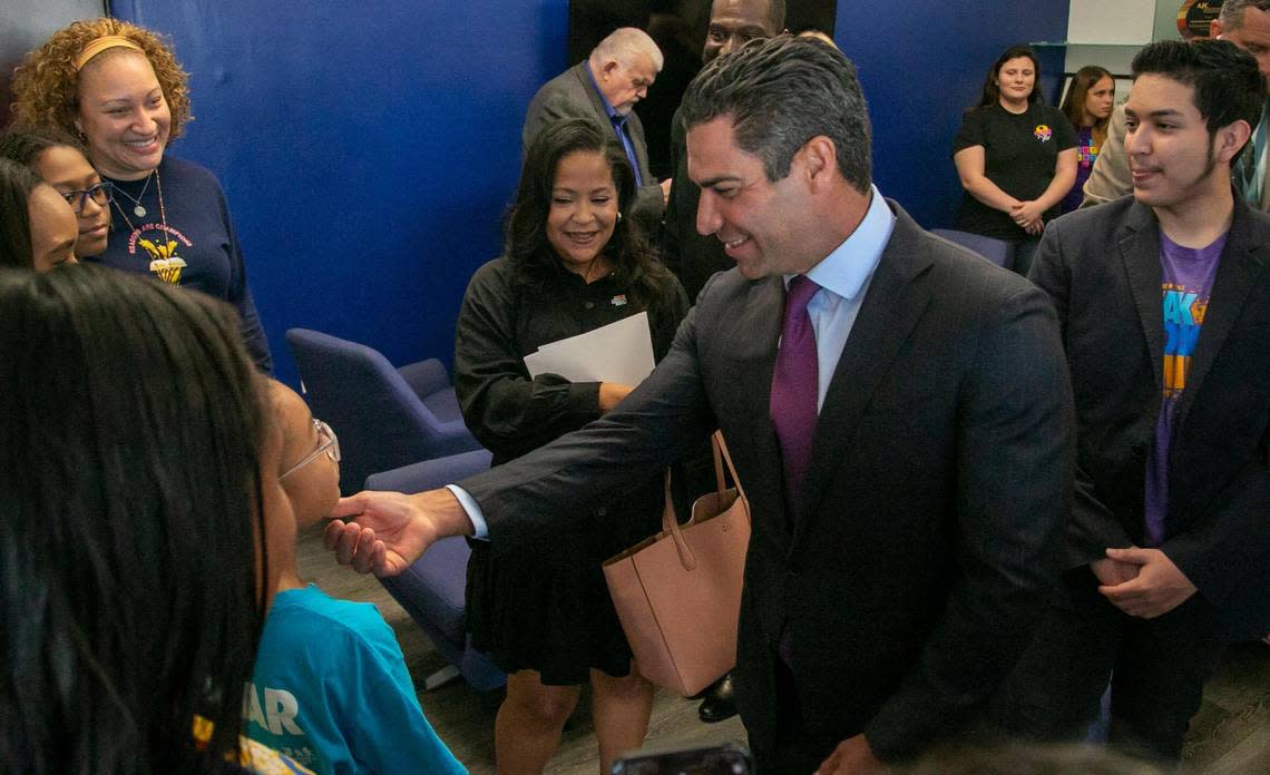 Miami FL- January 12, 2023 - City of Miami Mayor, Francis Suarez, center, greets students just before the start of a press conference to announce the award of $250,000 in grants to STEM education organizations .