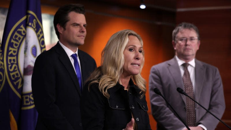 U.S. Rep. Marjorie Taylor Greene standing beside fellow ghouls Rep. Matt Gaetz and Rep. Thomas Massie.