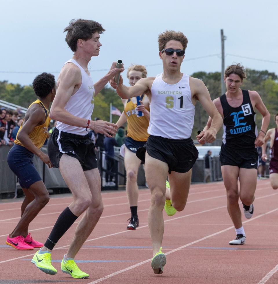 Southern Regional’s Drew Bowker takes the handoff from Santino D'Amelio in the 4X1600 relay. Ocean County Track and Field Relays in Stafford Township on May 5, 2023.