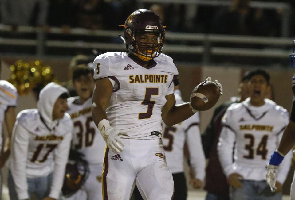 Salpointe's Bijan Robinson (5) smiles after making a one-handed sideline catch against Chandler's defense during their Open Division semifinal game at Hamilton High School in Chandler, Saturday, Nov 23, 2019