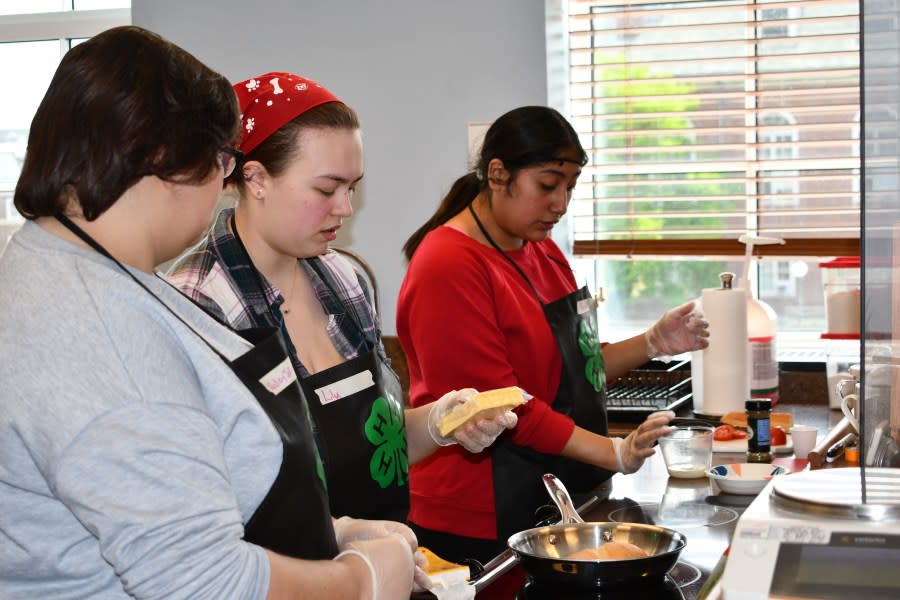 (From left to right) HaleyJo O’Neill, Lily Anderson and Theresa Domingo from Paxton-Buckley-Loda High School prepare their dish at the 4-H Regional Food Challenge on April 12, 2024. Photo courtesy of Illinois Extension.