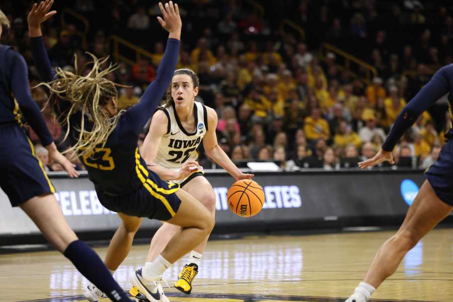 IOWA CITY, IOWA – MARCH 25: Caitlin Clark #22 of the Iowa Hawkeyes drives in as she collides with Lauren Fields #23 of the West Virginia Mountaneers during the second round of the 2024 NCAA Women’s Basketball Tournament held at Carver-Hawkeye Arena on March 25, 2024 in Iowa City, Iowa. (Photo by Rebecca Gratz/NCAA Photos via Getty Images)