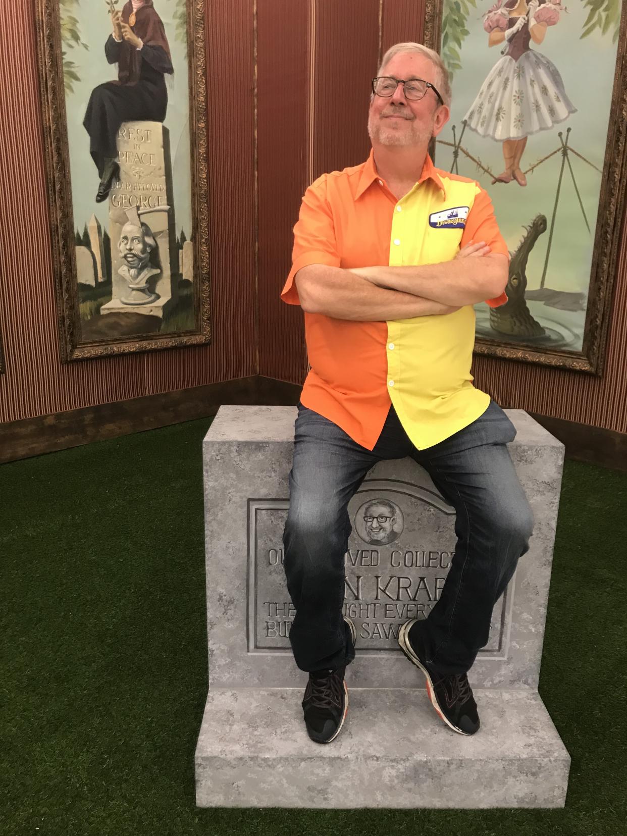 Disney Collector poses in front of a personalized tombstone, just like the ones outside the Haunted Mansion. (Photo: Yahoo Entertainment)