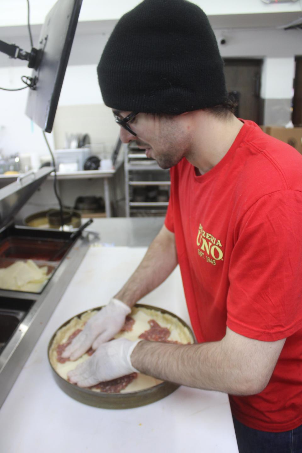 Andrew Budig makes a sausage and mushroom Chicago-style deep-dish pizza during the grand opening Oct. 20, 2023, of Pizzeria Uno in LaPorte inside the Pine Lake Resort and Banquets hotel.