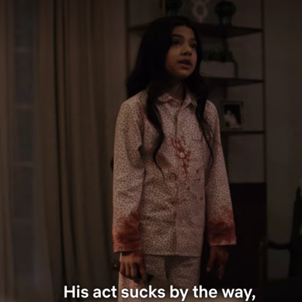 A young girl, Emma is bleeding while holding a weapon and saying, "His act sucks by the way."