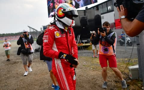 Ferrari's German driver Sebastian Vettel walks to the pits after he was forced to abandon during the German Formula One Grand Prix at the Hockenheim racing circuit on July 22, 2018 in Hockenheim, southern Germany.  - Credit: afp