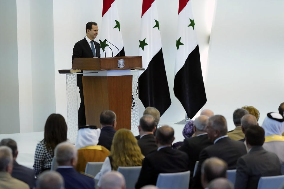 In this photo released by the official Facebook page of the Syrian Presidency, Syrian President Bashar Assad takes the oath of office for a fourth seven-year term, at the Syrian Presidential Palace in the capital Damascus, Syria, Saturday, July 17, 2021. In power since 2000, Assad's re-election in a landslide was not in doubt. His new term starts with the country still devastated by the 10-year war and sliding deeper into a worsening economic crisis. (Syrian Presidency via Facebook via AP)