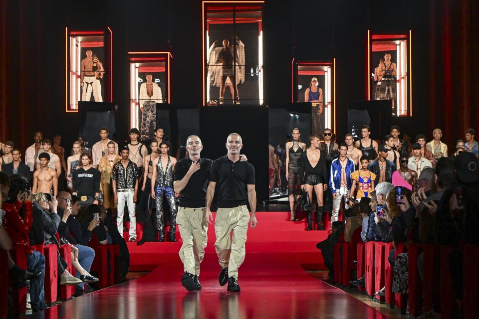 Designers Dean Caten and Dan Caten accept applause after the DSquared2 Spring Summer 2025 collection, that was presented in Milan, Italy, Friday, June 14, 2024. (AP Photo/Nicola Marfisi).