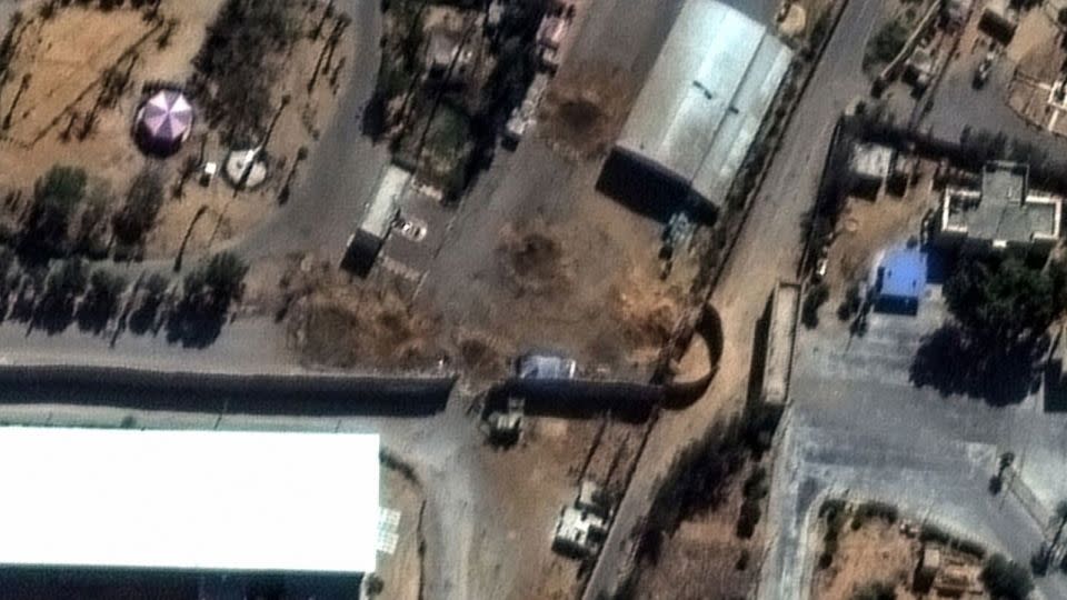 A satellite photo provided by MAXAR Technologies shows four 30-foot craters blocking the roadway at the Rafah border crossing closest to the Egyptian gate.  - Maxar Technologies