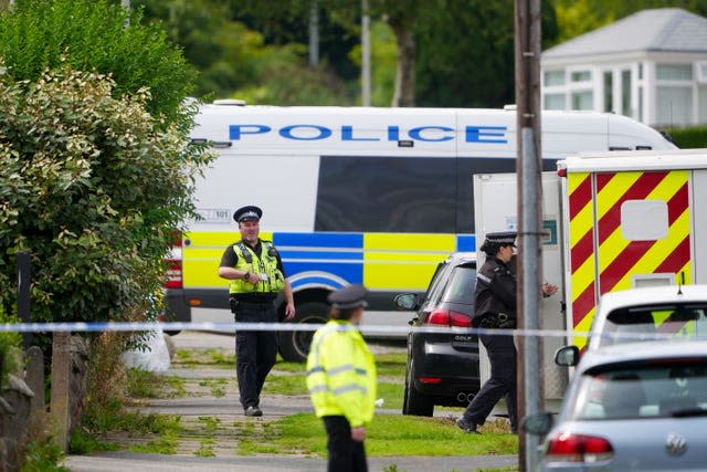 Emergency services in Westbury Road, Bradford, following a house fire where four people, including three children, died