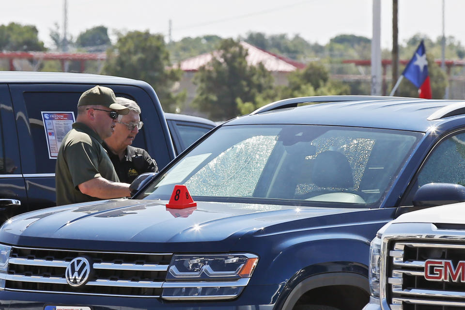 Officials continue to work the scene, Monday, Sept. 2, 2019, in Odessa, Texas, where teenager Leilah Hernandez was fatally shot at a car dealership during Saturday's shooting rampage. (AP Photo/Sue Ogrocki)