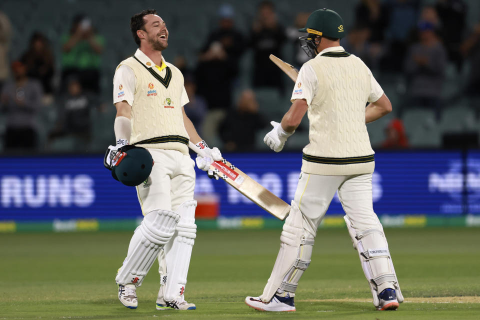 Australia's Travis Head, left, celebrates with teammate Marnus Labuschagne after Head made a century against the West Indies during their cricket test match in Adelaide, Thursday, Nov. 8, 2022. (AP Photo/James Elsby)