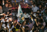 A vehicle carrying former Pakistani Prime Minister Nawaz Sharif is surrounded by his supporters following his release from prison in Rawalpindi, Pakistan, Wednesday, Sept. 19, 2018. The Islamabad High Court set him and his daughter and son-in-law free on bail Wednesday pending their appeal hearings. The court made the decision on the corruption case handed down to the Sharifs by an anti-graft tribunal earlier this year. (AP Photo/Anjum Naveed)