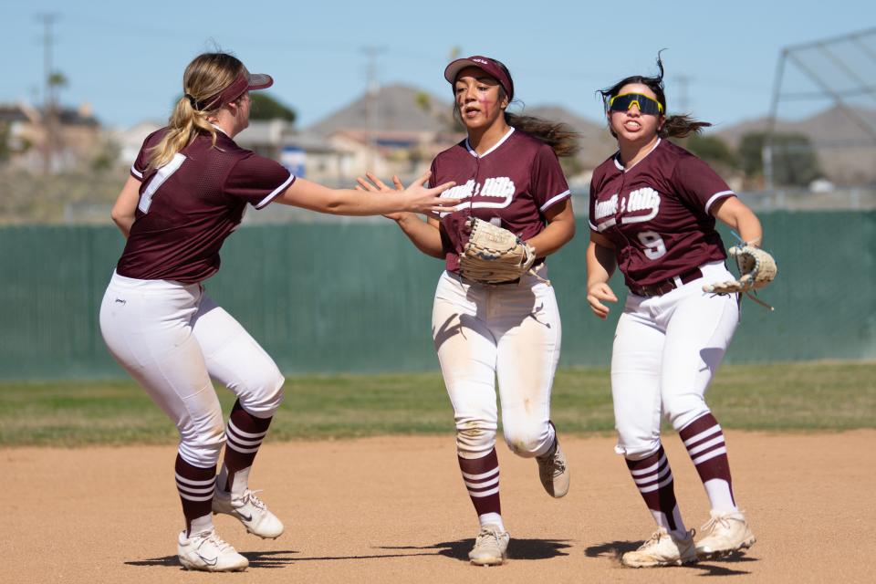 Granite Hills’ Mariah Maestas, center, celebrates with Saylor Croom, left, and Mia Vazquez at the end of the inning after catching a fly ball to left field. Granite Hills defeated Academy of Academic Excellence 7-5 on Tuesday, March 19, 2024 in Apple Valley.