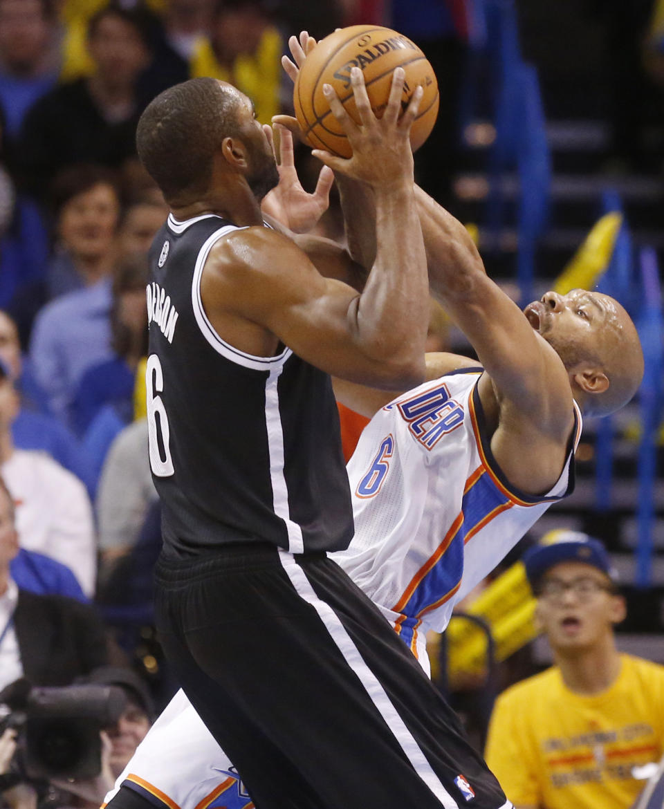 Oklahoma City Thunder guard Derek Fisher (6) fouls Brooklyn Nets guard Alan Anderson (6) as he shoots during the fourth quarter of an NBA basketball game in Oklahoma City, Thursday, Jan. 2, 2014. Oklahoma City won 95-93. (AP Photo/Sue Ogrocki)