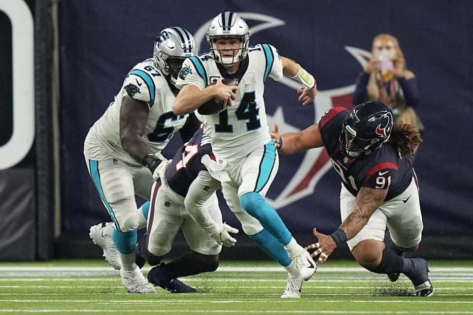 Carolina Panthers quarterback Sam Darnold (14) breaks away from Houston Texans defensive tackle Roy Lopez (91) during the second half of an NFL football game Thursday, Sept. 23, 2021, in Houston. (AP Photo/Eric Christian Smith)