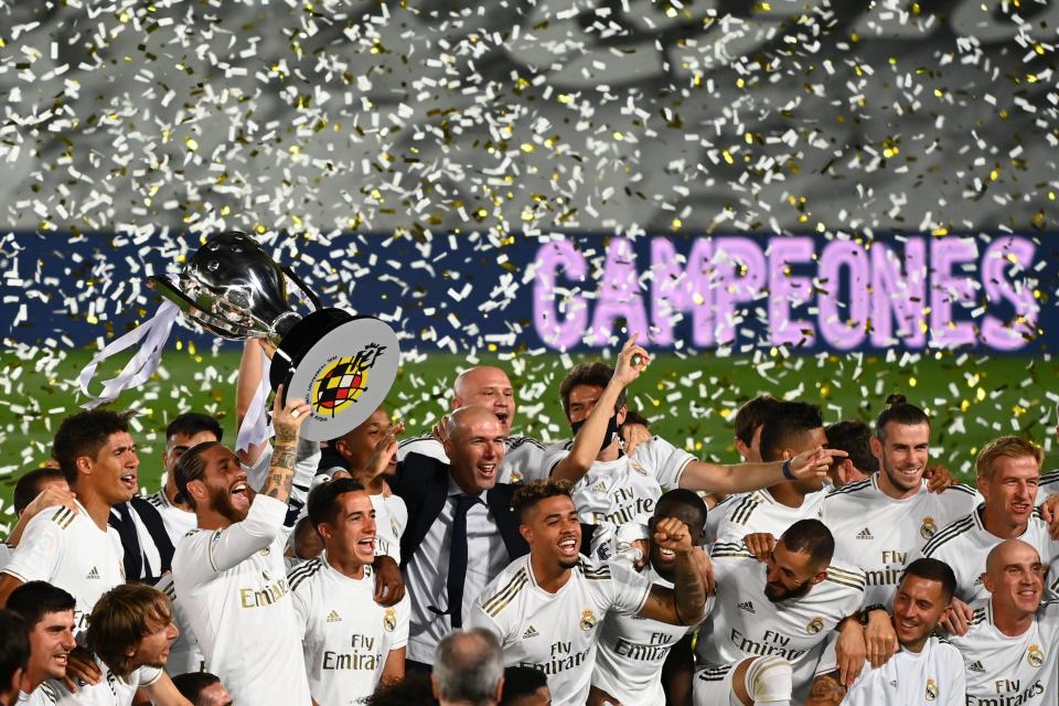 Real Madrid celebrates its La Liga crown after beating Villarreal 2-1 on Thursday. (Photo by GABRIEL BOUYS/AFP via Getty Images)