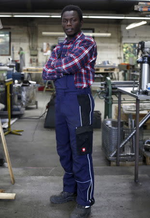 Yamoussa Sylla, 22, from Guinea, poses during his apprenticeship for a metal worker at 'WBG Blechverarbeitung GmbH' in Schwerte, Germany, October 5, 2015. Picture taken October 5, 2015. REUTERS/Ina Fassbender