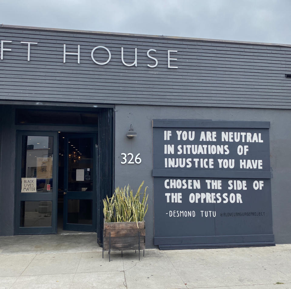 A Love Language Project has been using storefronts and walls to amplify black voices. They created quote murals on Croft House's boarded-up windows (Alex Segal)