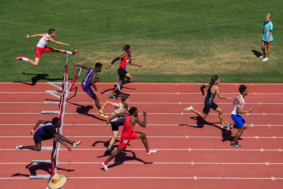 Students race the Boys 100 Meter Hurdles Division one race during the AIA State Track & Field Championships 2022 at Mesa Community College on Saturday, May 14, 2022, in Mesa. 