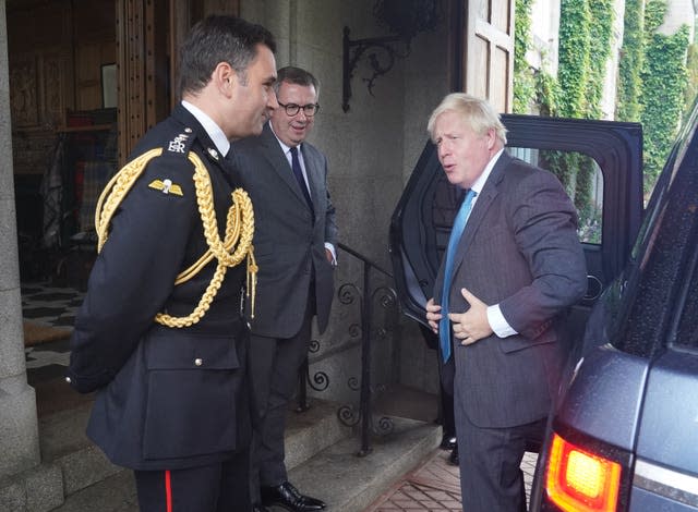 Outgoing prime minister Boris Johnson is greeted by the Queen Elizabeth II’s Equerry Lieutenant Colonel Tom White and her private Secretary Sir Edward Young as he arrives at Balmoral for an audience to formally resign (Andrew Milligan/PA)