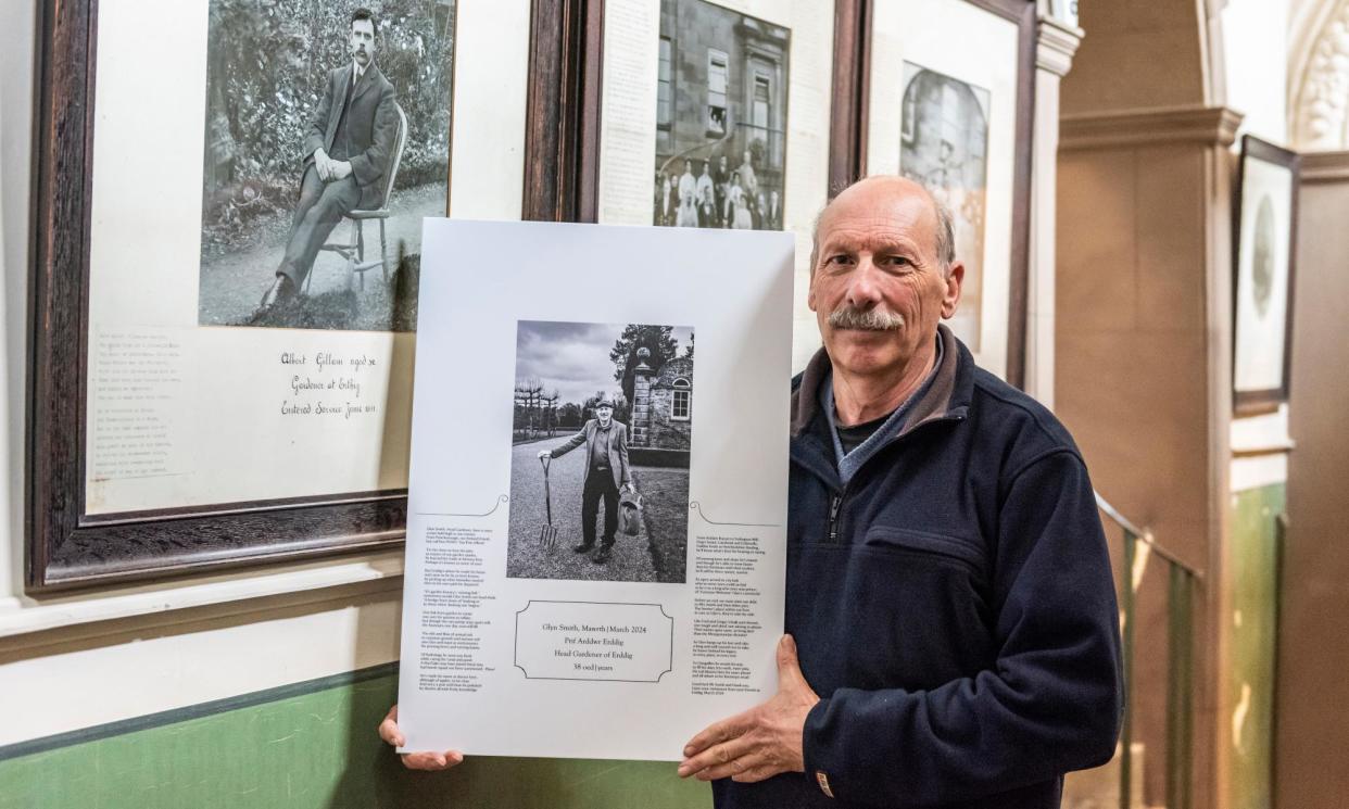 <span>Glyn Smith, who spent 38 years working at Erdigg, displays his portrait alongside that of Albert Gillam, another gardener who began the same job in June 1911.</span><span>Photograph: Paul Harris Photography/National Trust/Paul Harris</span>