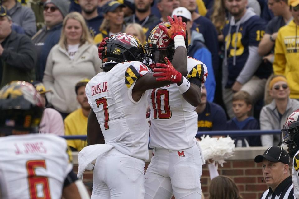 Maryland wide receiver Tai Felton (10) celebrates his four-yard touchdown reception with Dontay Demus Jr. (7) in the second half of an NCAA college football game against Michigan in Ann Arbor, Mich., Saturday, Sept. 24, 2022. (AP Photo/Paul Sancya)