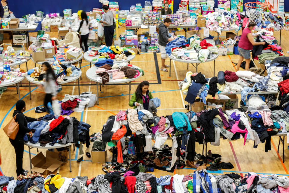Evacuees look through donated goods