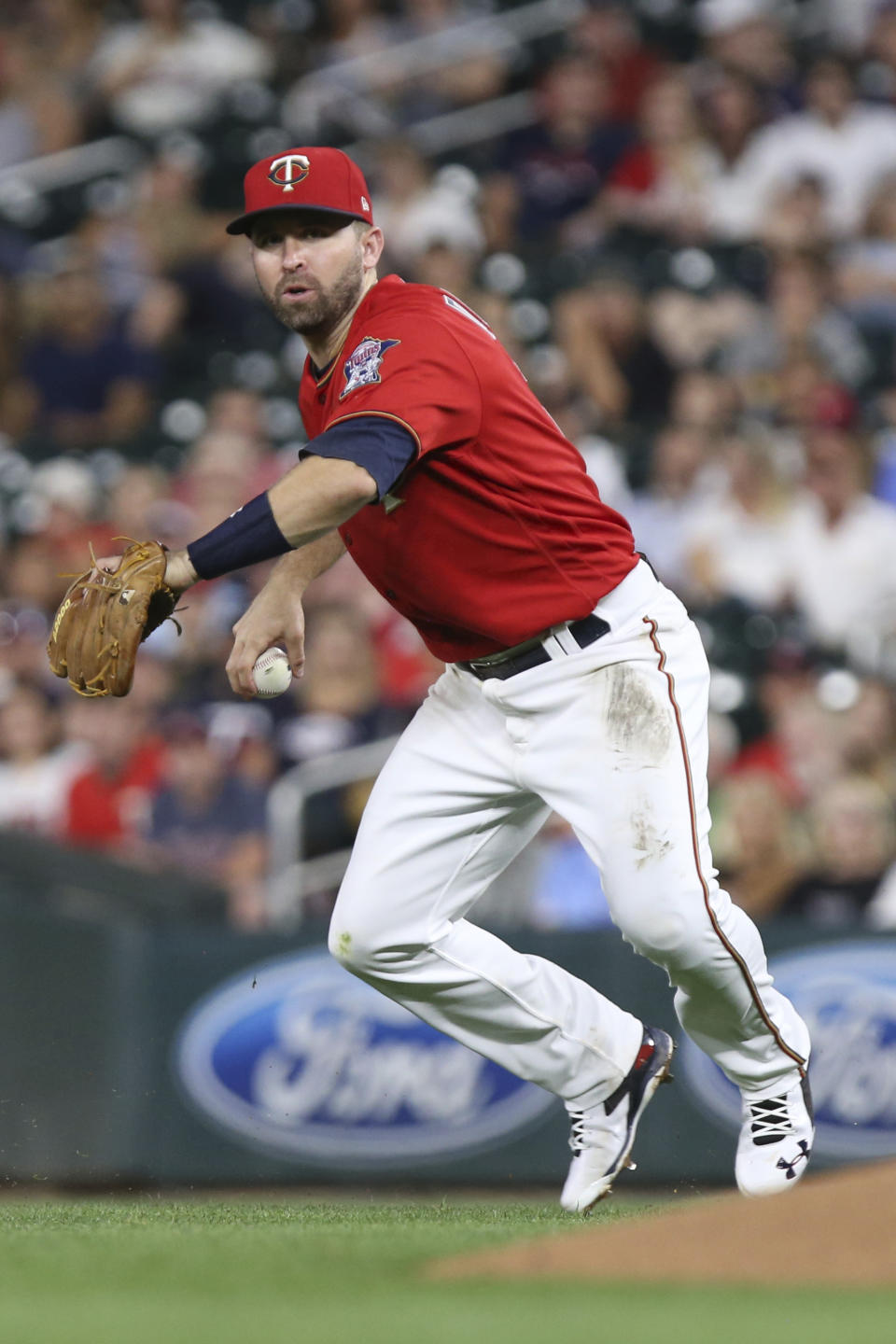 Minnesota Twins' Brian Dozier looks to throw the ball against the Cleveland Indians in the sixth inning of a baseball game Monday, July 30, 2018 in Minneapolis. Minnesota won 5-4. (AP Photo/Stacy Bengs)