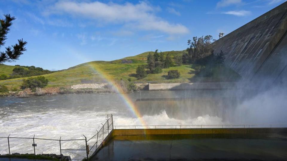 A rainbow forms in the mist at the base of Friant Dam where releases are in excess of 8,000 cubic feet per second on Tuesday, April 11, 2023 to make way in Millerton Lake for the massive snow pack in the Sierra Nevada that will continue to melt in the coming weeks and months.