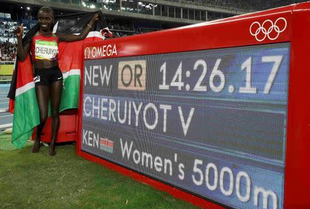 2016 Rio Olympics - Athletics - Final - Women's 5000m Final - Olympic Stadium - Rio de Janeiro, Brazil - 19/08/2016. Vivian Cheruiyot (KEN) of Kenya celebrates after setting a new olympic record and winning gold. REUTERS/Phil Noble