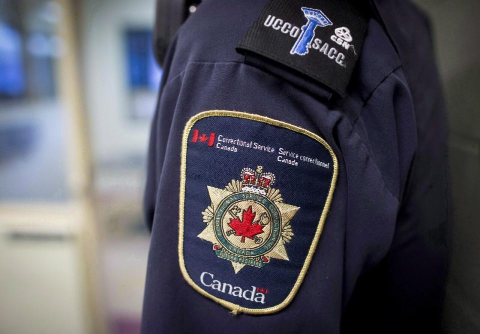 Patches are seen on the arm and shoulder of a corrections officer in the segregation unit at the Fraser Valley Institution for Women during a media tour, in Abbotsford, B.C., on Thursday October 26, 2017.