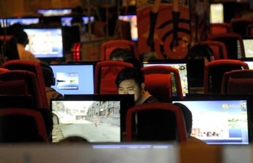 People surf the internet in a cafe in Beijing in 2011. A Chinese military official has been suspended and placed under investigation over accusations of a drunken assault on a flight attendant after pictures of her alleged injuries emerged on Sina Weibo, state media said Tuesday. China has the world's largest online population with more than half a billion users, a challenge to government control