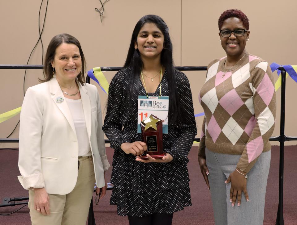 Somerset County Commissioner Deputy Director Melonie Marano, left, and Somerset County Commissioner Director Shanel Robinson, right, present first-place winner, Nitya Kathiravan, her award.