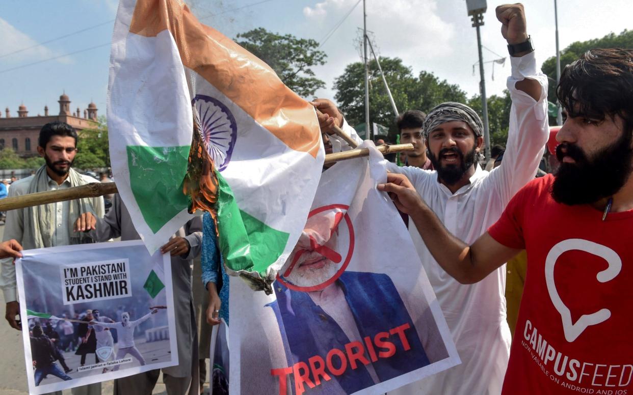 Students of Islami Jamiat-e-Talaba, a wing of religious political party Pakistan Jamaat-e-Islami, burn a photograph of Indian Prime Minister Narendra Modi - AFP