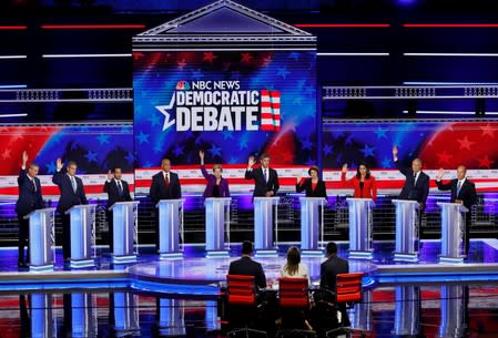 Candidates raise hands at the first U.S. 2020 presidential election Democratic candidates debate in Miami, Florida, U.S.,