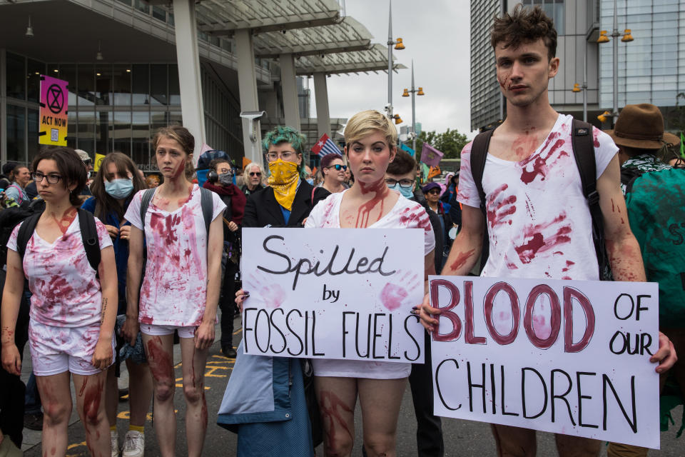 Environmental activists covered in fake blood demonstrate in London.