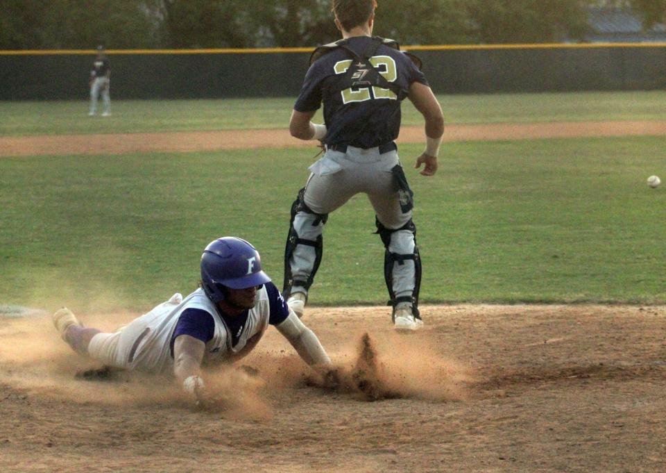 Fletcher's Angel Oquendo (7) slides into home with the eventual game-winning run against Sandalwood during the Gateway Conference baseball championship on April 22, 2022. [Clayton Freeman/Florida Times-Union]