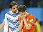 Goalkeeper Tim Krul (L) of the Netherlands consoles his teammate Daryl Janmaat after losing their 2014 World Cup semi-finals against Argentina at the Corinthians arena in Sao Paulo July 9, 2014. REUTERS/Darren Staples