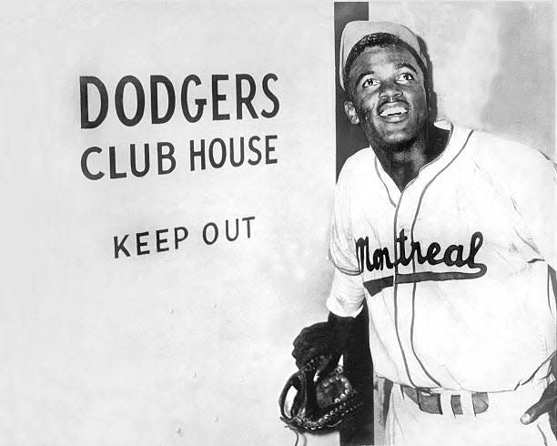 UNITED STATES - APRIL 10:  Jackie Robinson, the first black to be admitted to the major leagues, enters the Brooklyn Dodgers' clubhouse after the Dodgers announced they had purchased hs Montreal Expo contract.  (Photo by NY Daily News Archive via Getty Images)