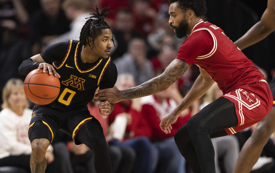 Nebraska's Brice Williams, right, defends against Minnesota's Elijah Hawkins during the first half of an NCAA college basketball game, Sunday, Feb. 25, 2024, in Lincoln, Neb. (AP Photo/Rebecca S. Gratz)