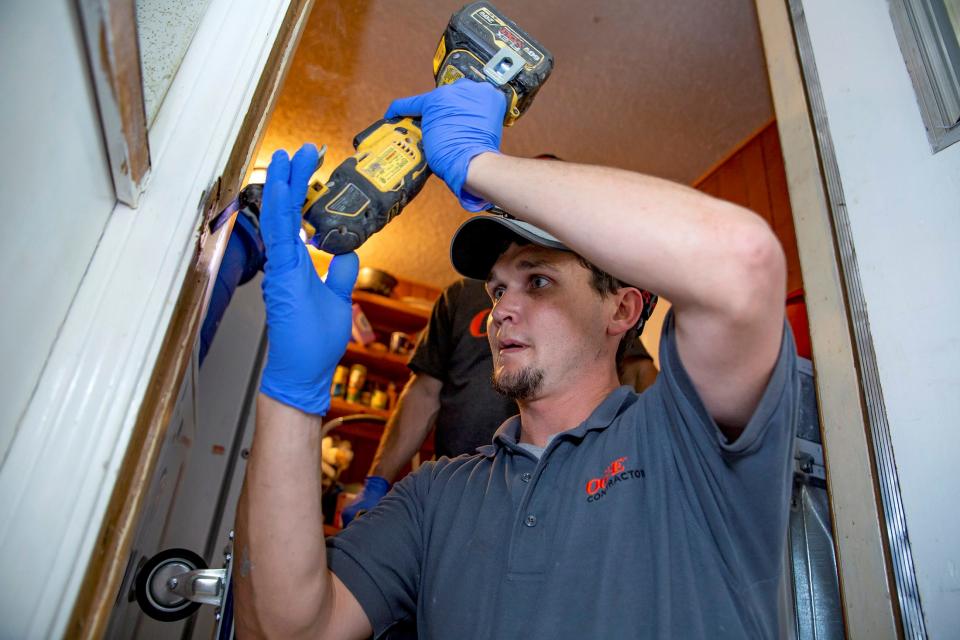 A door jam gets repaired as part of an Oklahoma Gas and Electric weatherization upgrade on a customer's home. The Oklahoman File