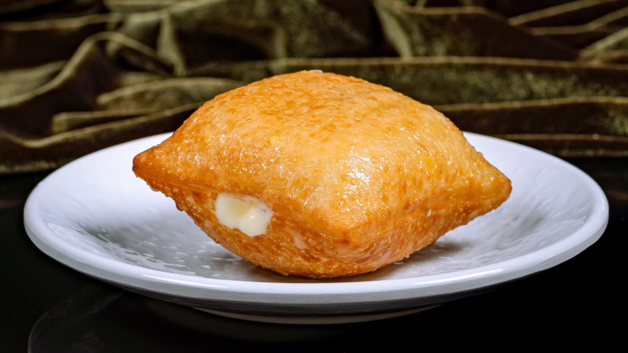 House-filled Beignet – featuring lemon ice box pie filling topped with lemon glaze.