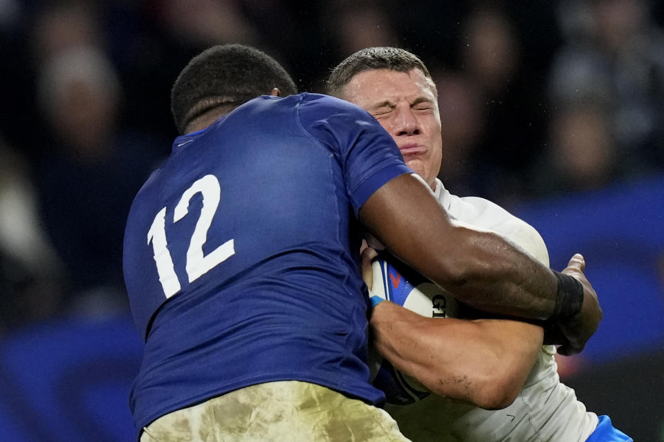 Italy's Paolo Garbisi hits France's Jonathan Danty during the Rugby World Cup Pool A match between France and Italy at the OL Stadium in Lyon, France, Friday, Oct. 6, 2023. (AP Photo/Pavel Golovkin)