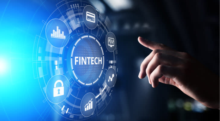 undervalued fintech stocks A concept image of a hand reaching toward the word "Fintech," which is surrounded by icons representing money and growth. Fintech Stock Bargains, fintech stock