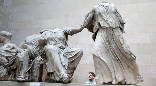 A man views the Parthenon Marbles, a collection of stone objects, inscriptions and sculptures, also known as the Elgin Marbles, in the British Museum.