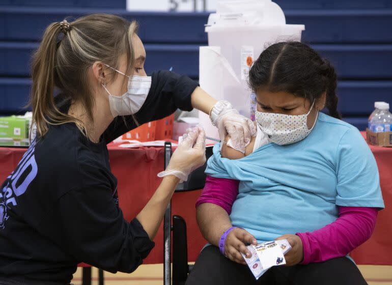 ARLETA, CA - NOVEMBER 08: Sarginoor Kaur (cq), 7, gets the COVID-19 vaccine from nurse Chelsea Meyer at Arleta High School on Monday, Nov. 8, 2021. Following the recent Centers for Disease Control and Prevention's approval of Pfizer's COVID-19 vaccine for children ages 5 to 11, Los Angeles Unified will offer voluntary vaccine access to students. The district highly encourages the vaccine for children ages 5 to 11, however, it will not be part of Los Angeles Unified's current student vaccine requirement. (Myung J. Chun / Los Angeles Times)